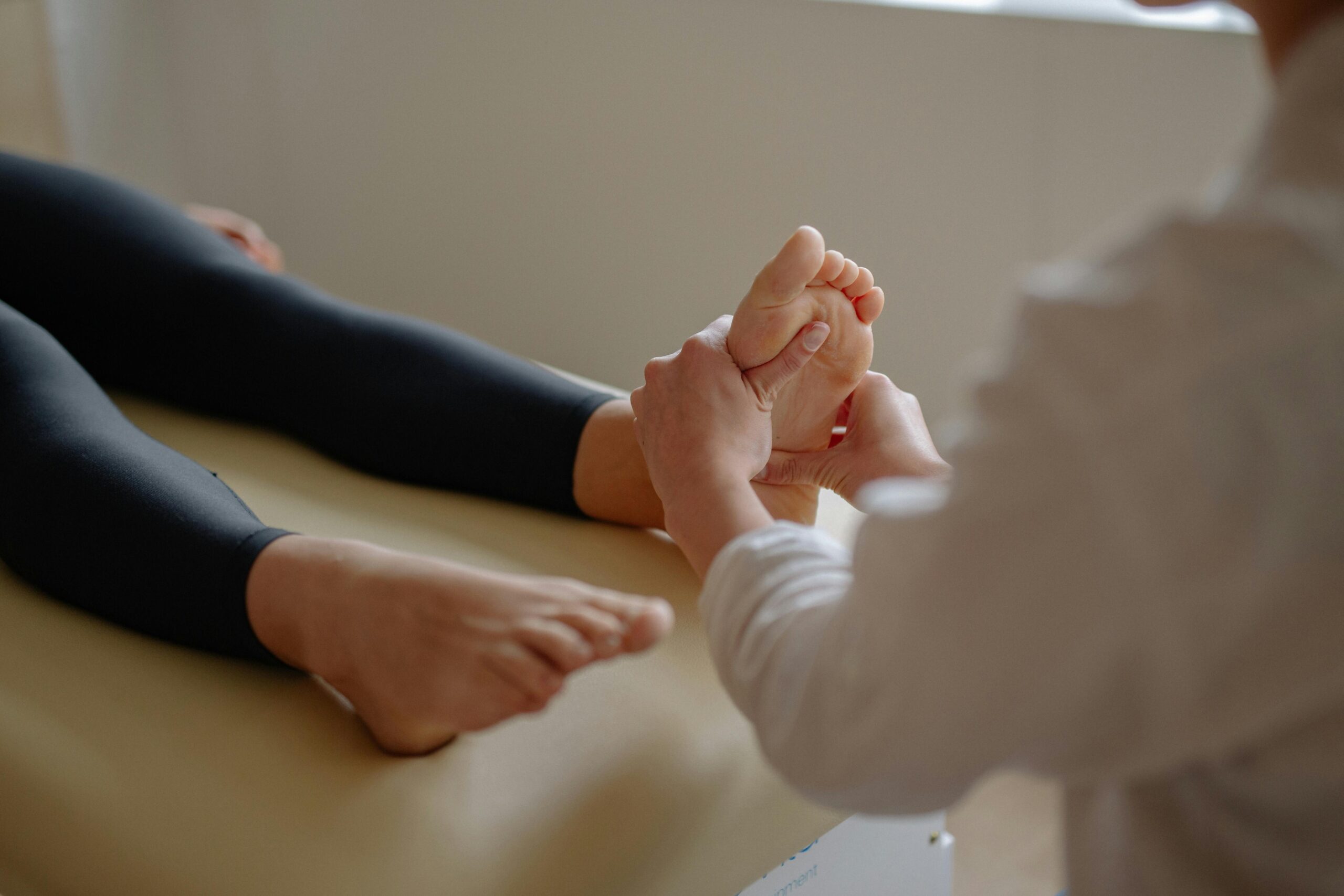 Practitioner treating and examining someones foot